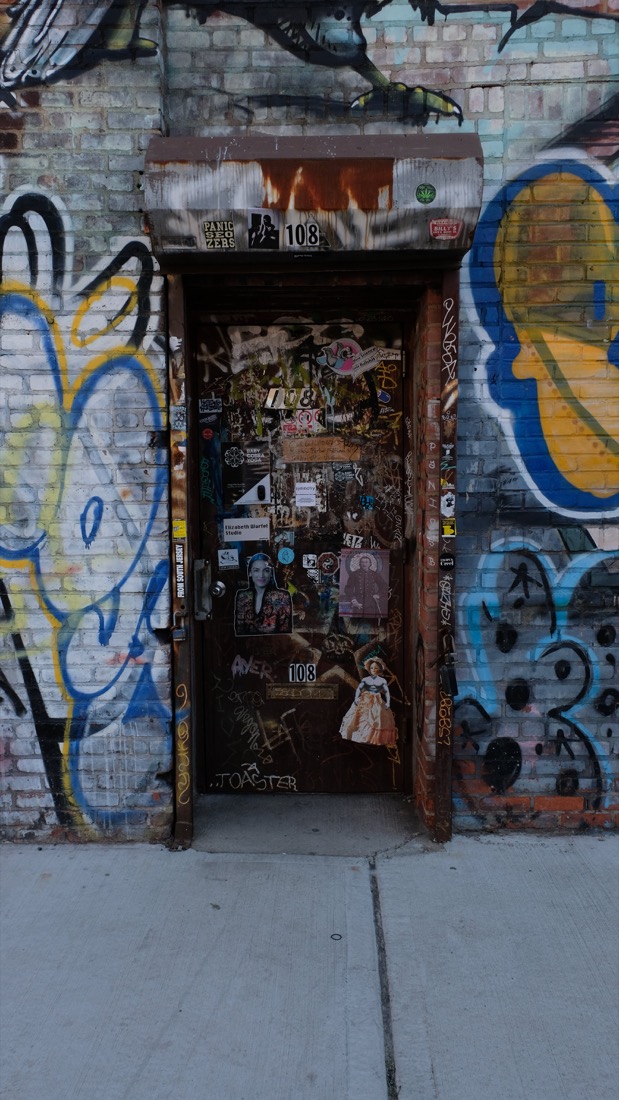 The graffiti-covered door at 108 Bayard Street, the Fitted Underground workshop in Williamsburg